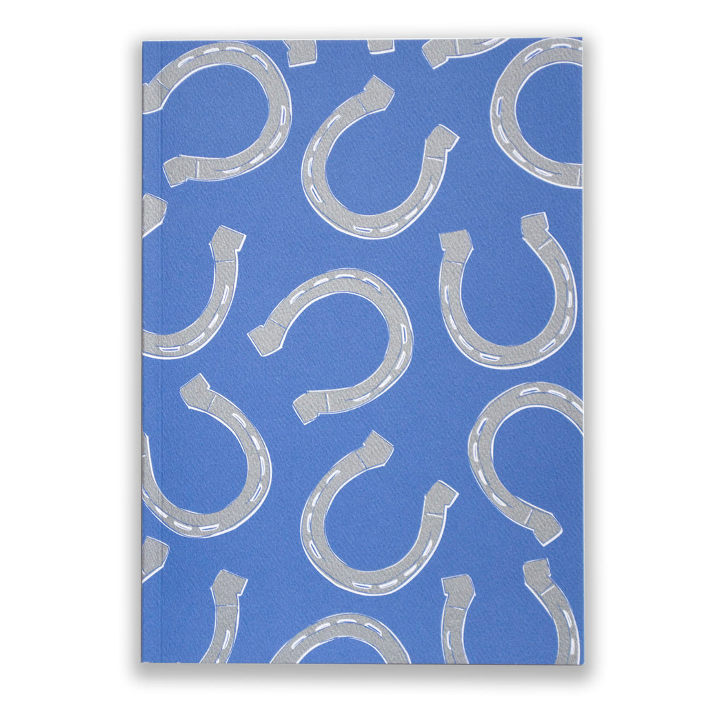 blank notebook with blue and silver horseshoes on the cover from and back 