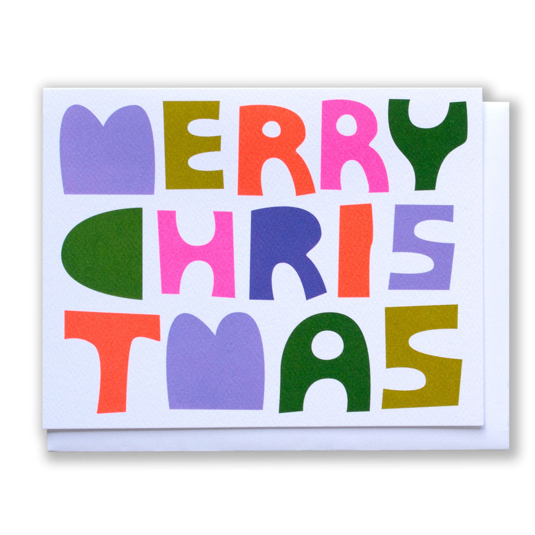 Holiday card with multicoloured text that says Merry Christmas in a hand drawn font that has a paper block cut look