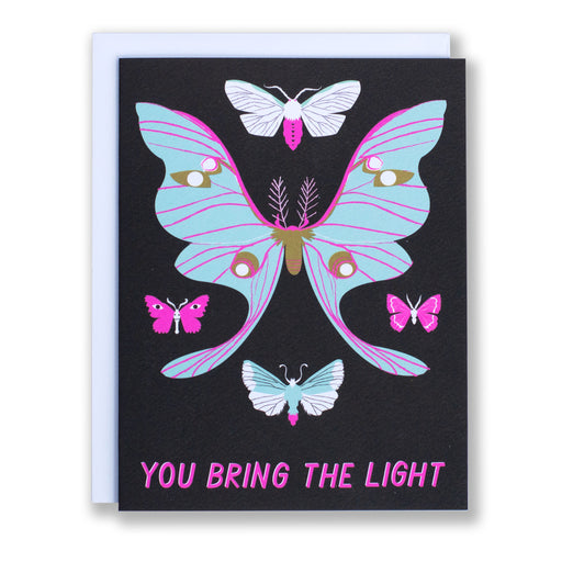 note card reads 'You Bring the Light' with a selection of moths in mint green and neon purple on a black background