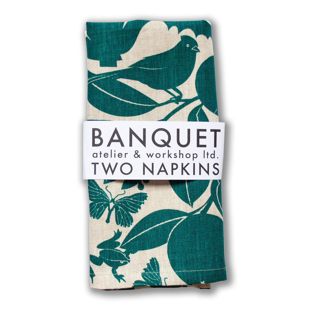 napkins printed with plants and animals in emerald green