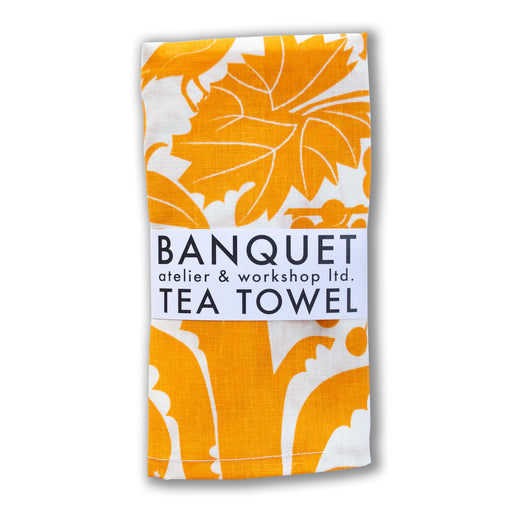 all linen tea towel screen printed with flora and fauna of California in a yellow-orange marigold colour