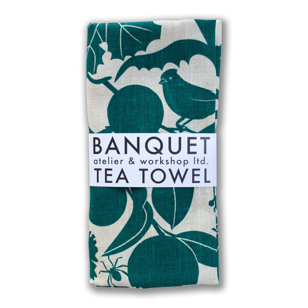 linen tea towel printed with the flora and fauna of a California vineyard. Emerald green on natural