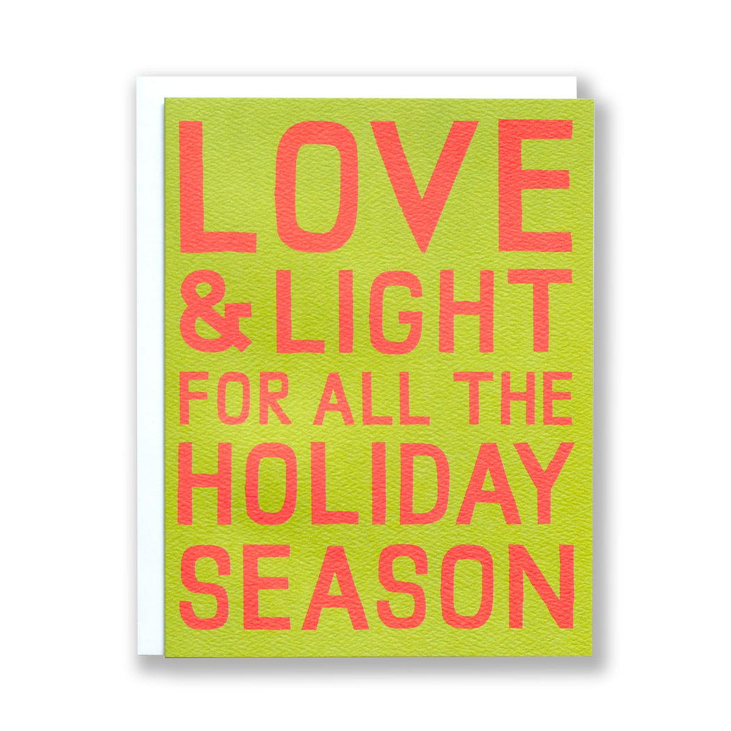 Note Card with red block text on olive green reading Love & Light for all the Holiday Season