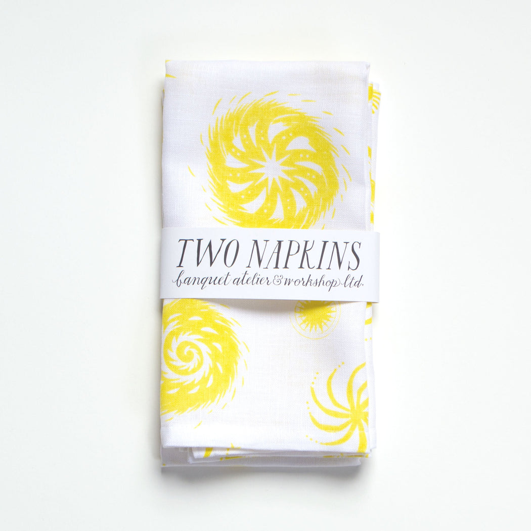 A pair of Lemon Yellow on White Fireworks Napkins